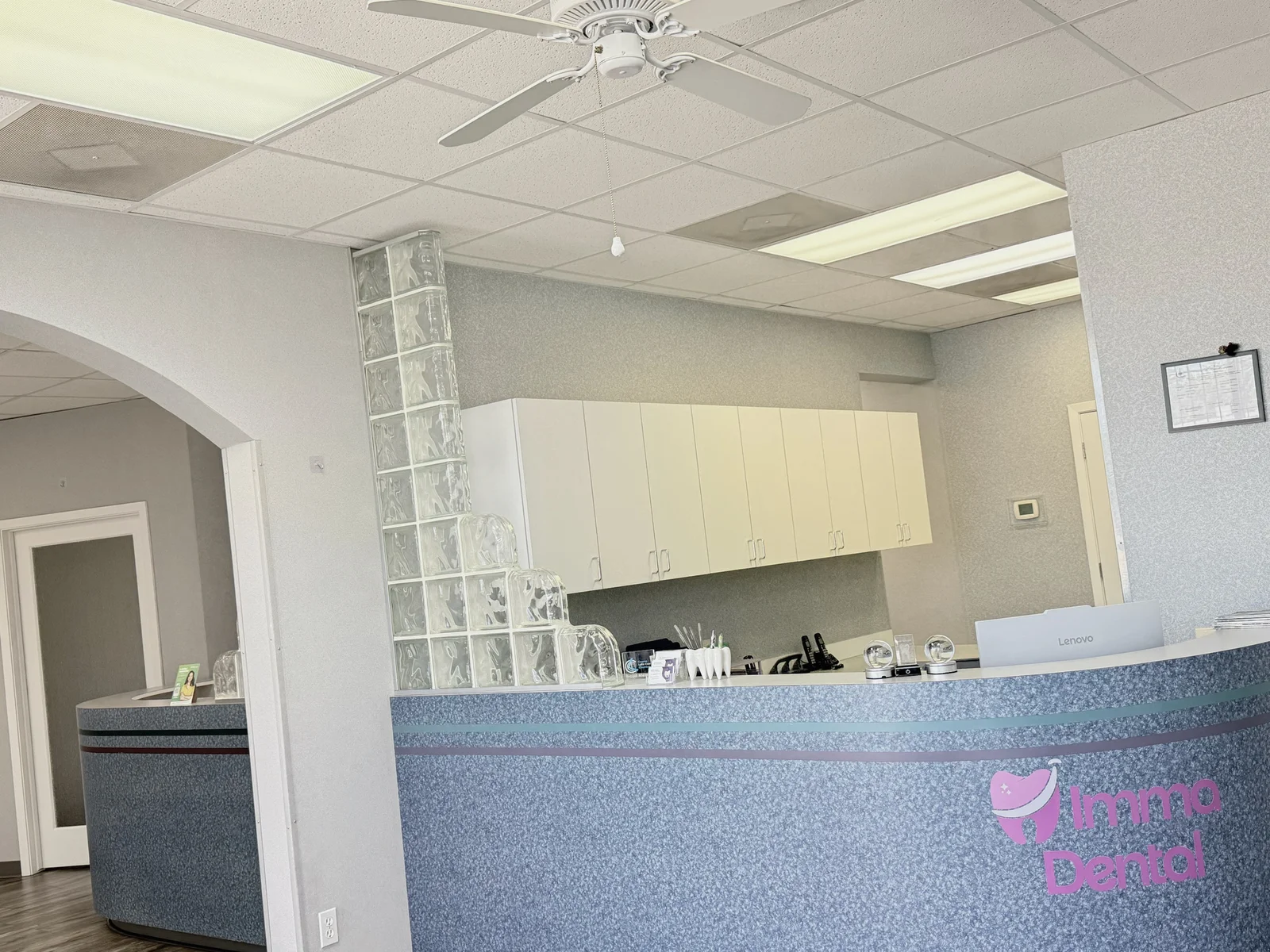 Imma Dental reception counter with the practice logo
